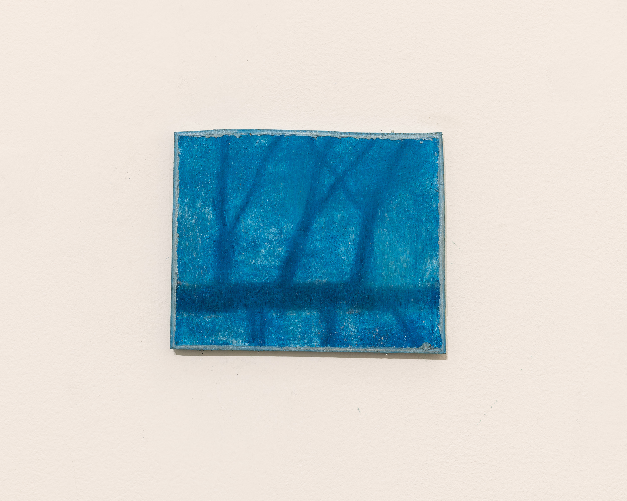 Installation views thesis exhibition containing colorful paintings stretched and unstretched, hanging in space and attached to the wall
