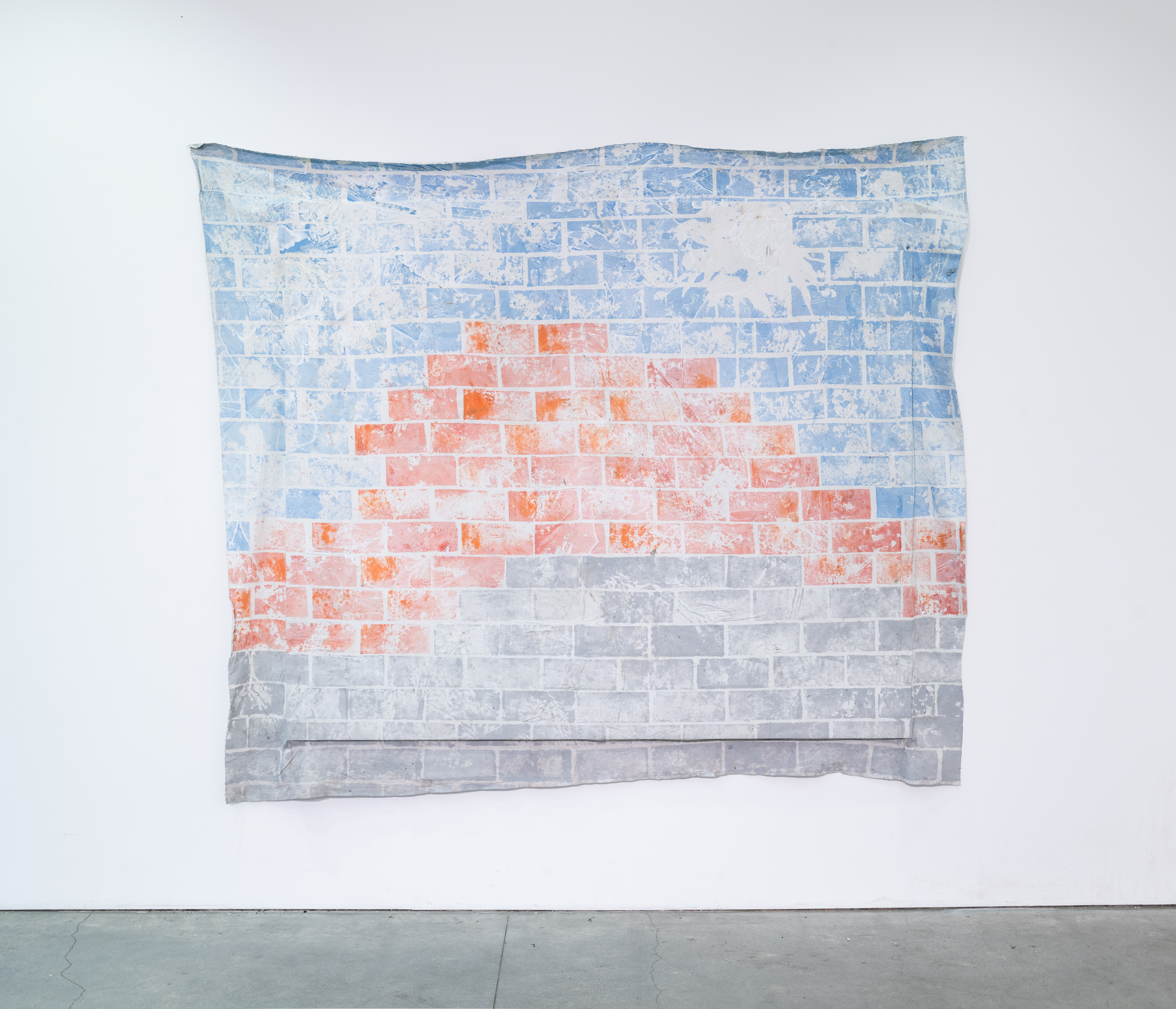 Bricked shapes on blues, orange and grey on a semi stretched canvas. 
