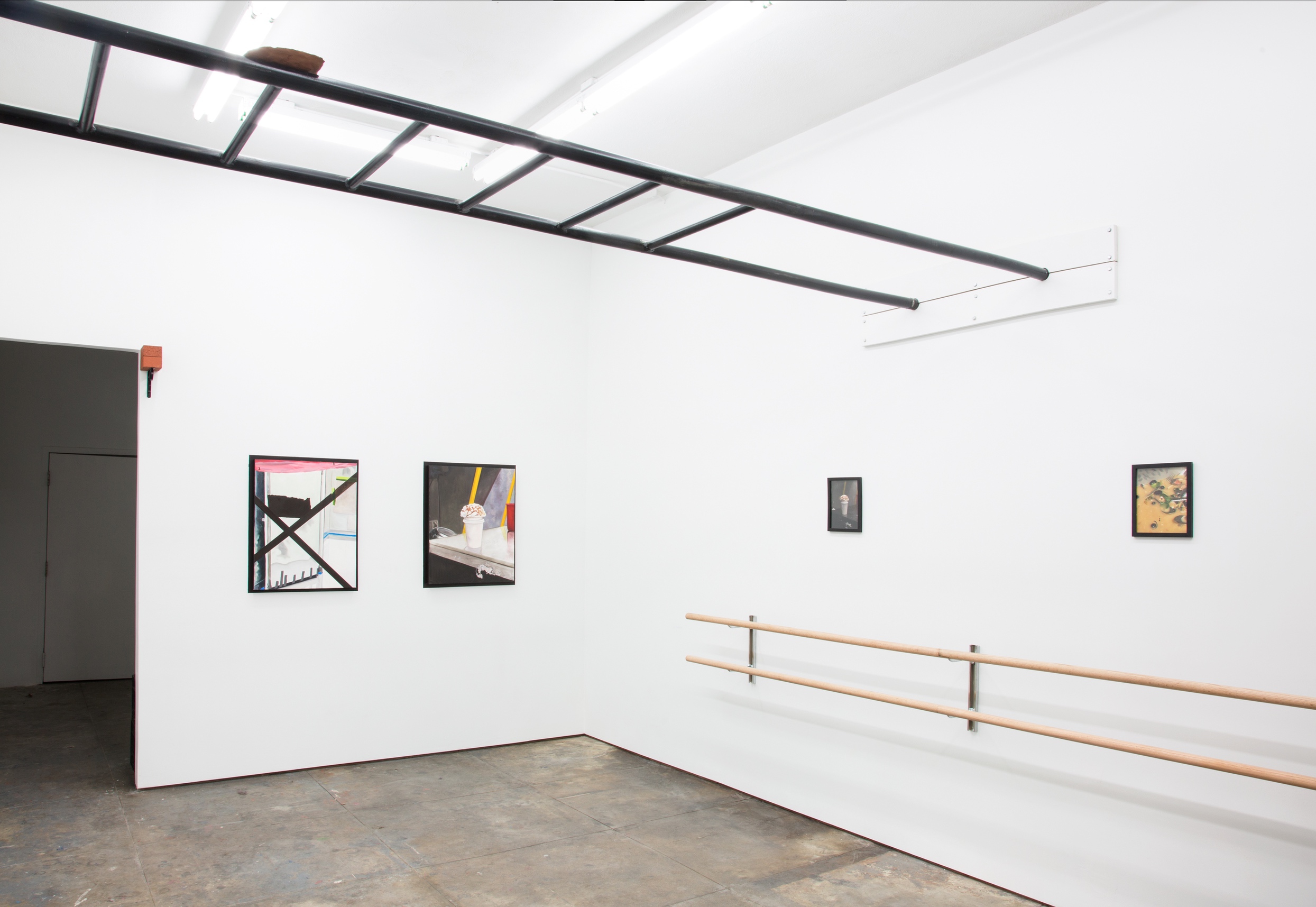 Installation image of Sparkling or still, an exhibition at In Lieu Gallery in Los Angeles. The picture is taken at a wide angle. The room is a bright white room with a gray concrete floor. There are two sets of ballet barres running along the walls and hung above them are 4 printed and framed images. The images are the reference photos for a series of four oil paintings that translate from the originals, also present within the room. Out-of-hand’s reach is a 300lb black steel monkey bar-like structure that runs from wall to wall. Resting on top of it is an unfired clay tablet which sits precariously on top of the structure.  The clay tablet has the 10 Commandments scratched onto the front and the back of the surface.