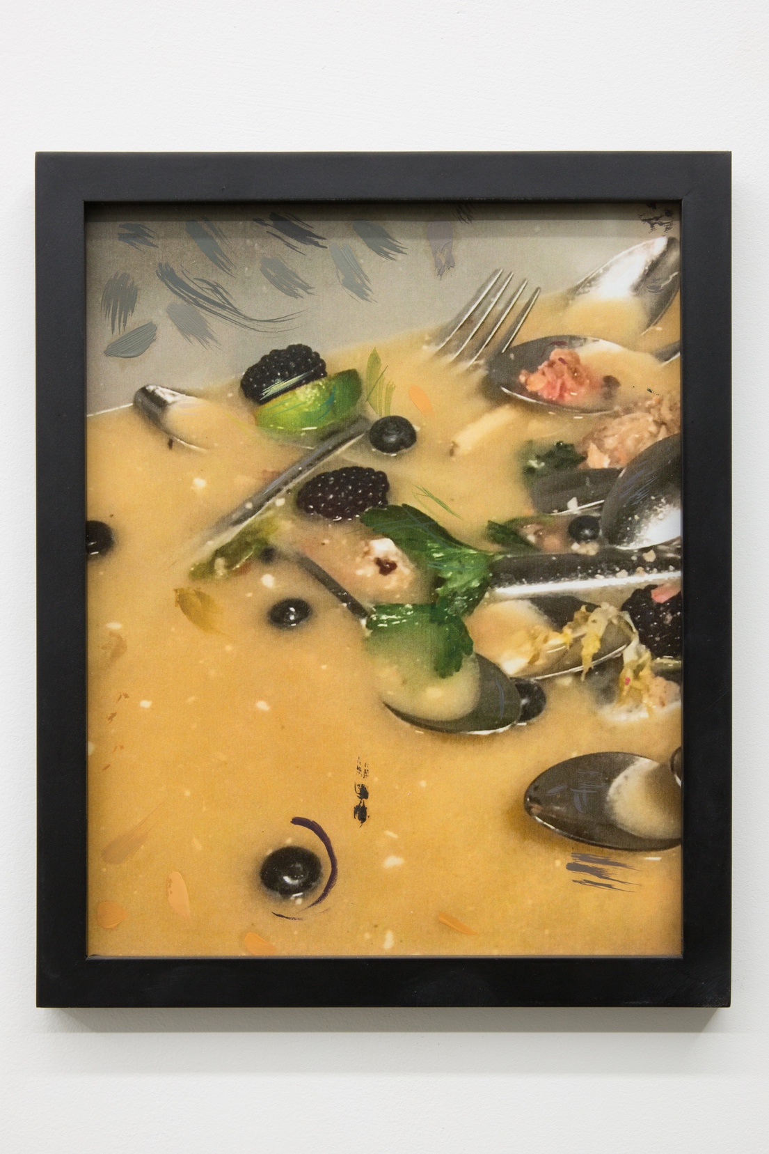 Detail image of a printed photograph framed in a thin matte black frame. The printed image has small marks of oil paint. The image is of the inside of a restaurant's dirty dish bin. The water is a slightly muddy yellow color and the bin is filled with assorted cutlery and cocktail garnishes.