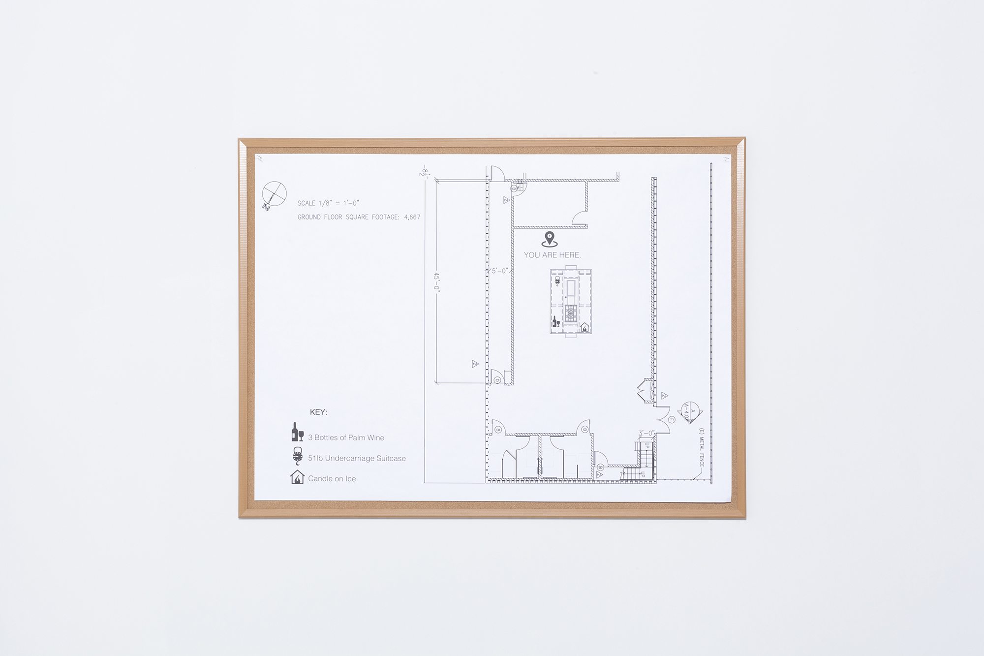 Detail image of an architectural blueprint. The original blueprint was edited and manipulated by the artist. On the left hand corner is a key which tells you the contents of the center structure. It reads: 3 Bottles of Palm Wine, 51lb Undercarriage Suitcase, Candle on Ice.