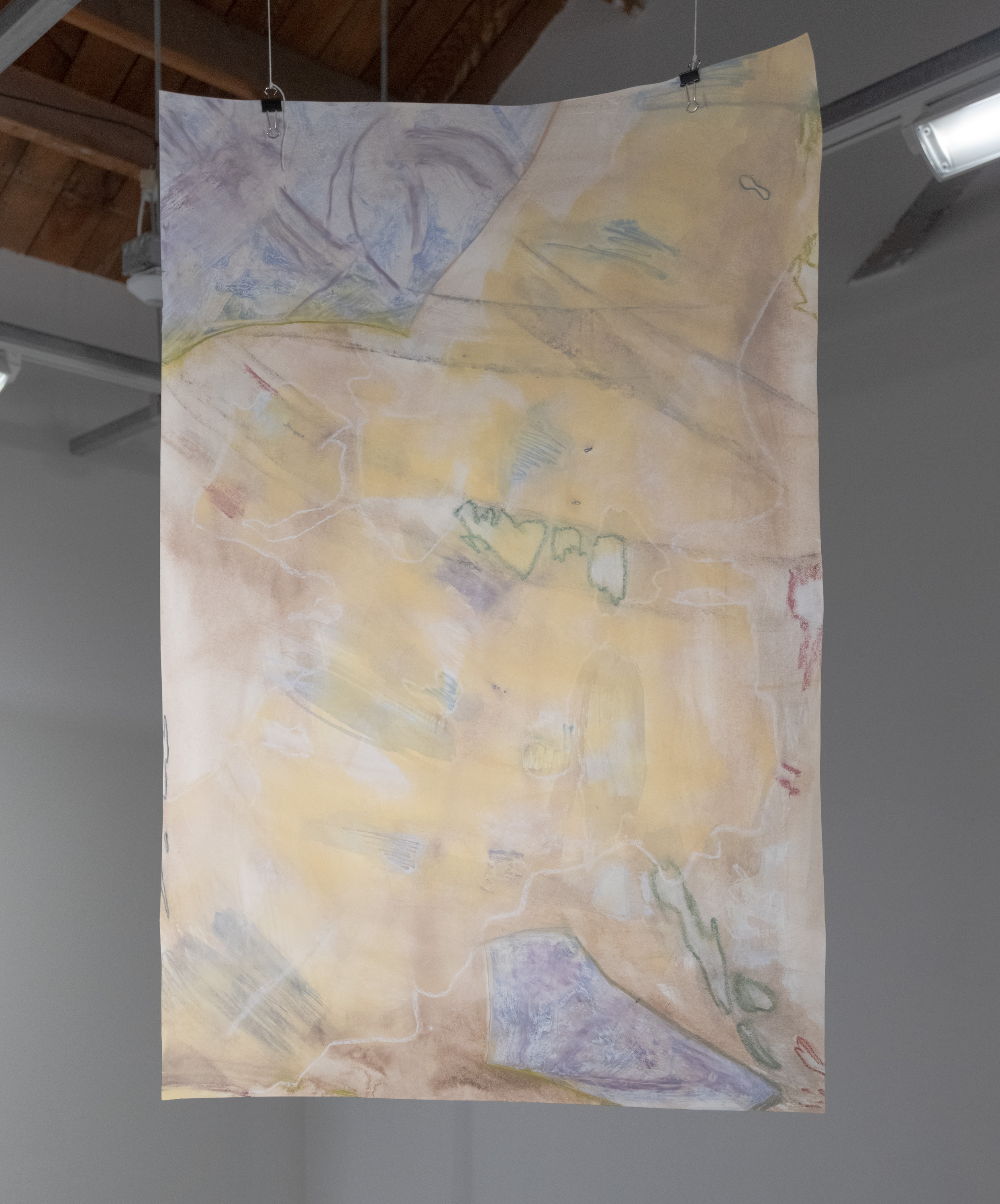 Sheet of paper coated with walnut ink suspended from the ceiling. Abstract collage mylar pieces lay on top left and bottom right. These are colored with strokes of French blue and lavender. Strokes of pale yellow run through the remaining negative spaces. Lingering residual watermarks from pale yellow are outlined with white chalk. Smaller residual watermarks from multiple layers are outlined in purple, green, burgundy, and blue.