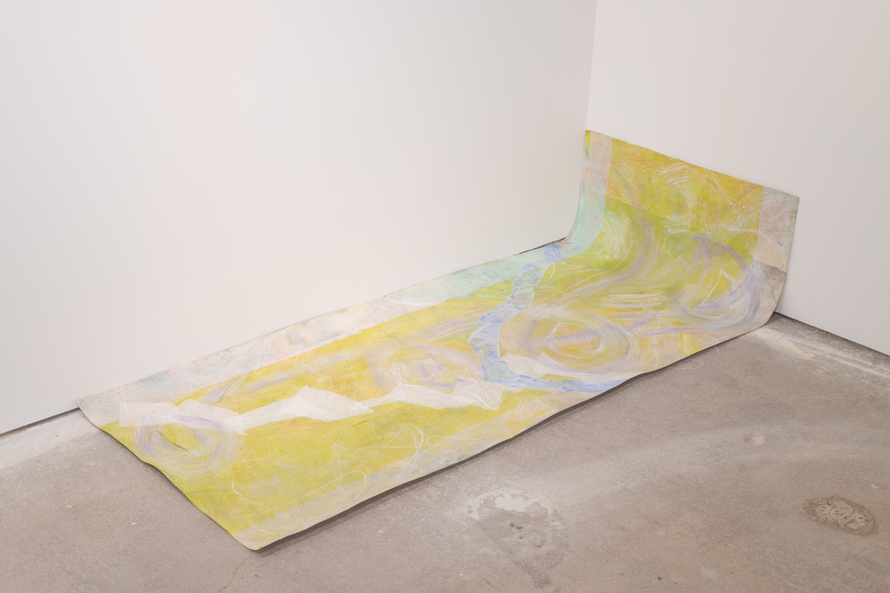 Lime green rectangle sitting in slouching position in the corner of the room. The top fifth of it sits against the wall as the rest of the paper sits on the floor. Paper is occupied with two cream colored bars running through the top and bottom. Large lavender cursive swirls run through the entire work applied with a squeegee. Leftover collaged pieces of mylar and tracing paper sit in the foreground. The mylar is coated with a wash of French blue. Various pastel colors peek through the multiple layers.
