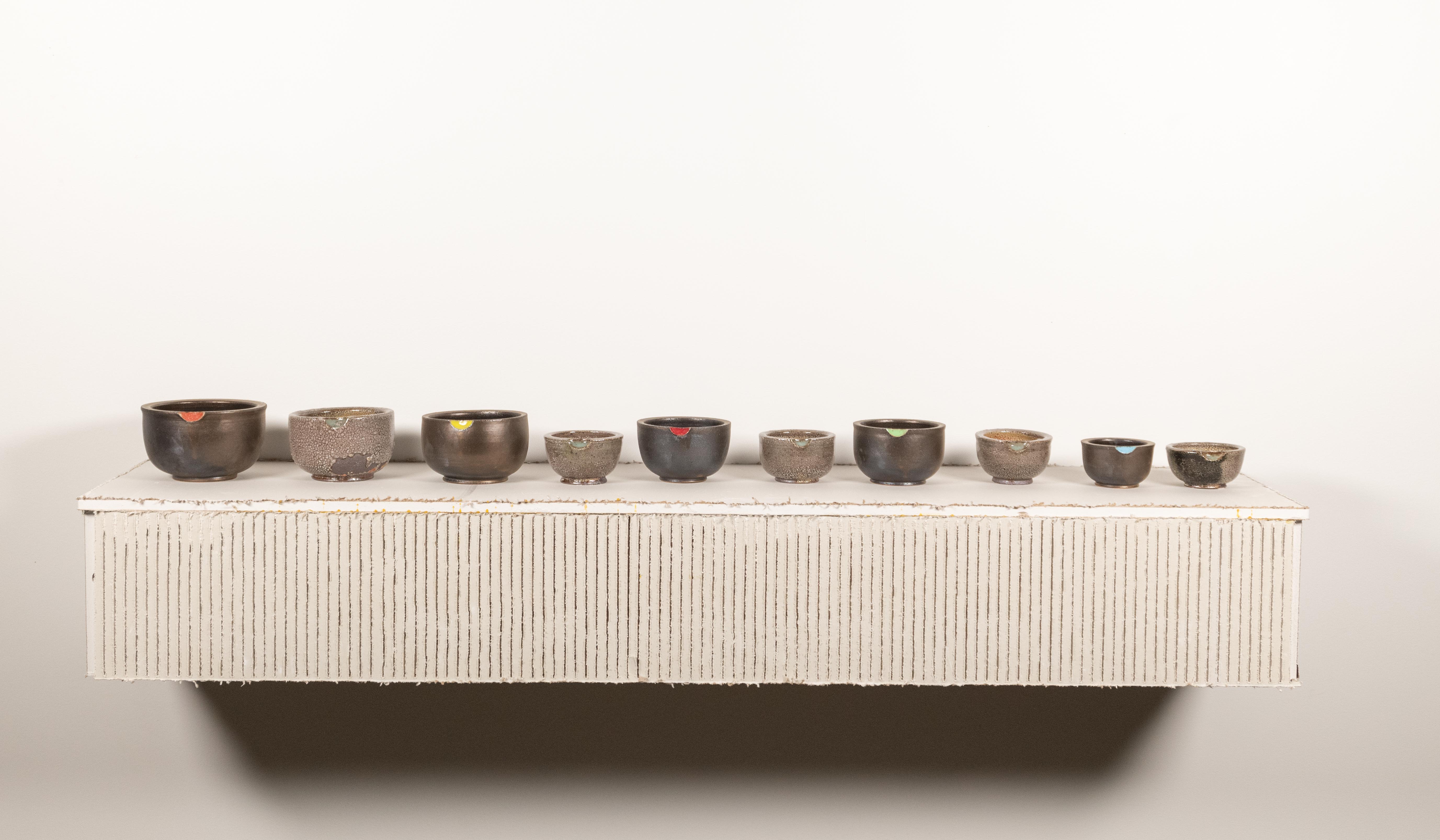 Blue chalk line’s create a 1 point perspective horizon line on the lower half of the paper. Red
lines rise up from the horizon lines acting like lines in a composition notebook. On the top of
the page USER Manual 2020-2021 is written over and over again in different fonts.