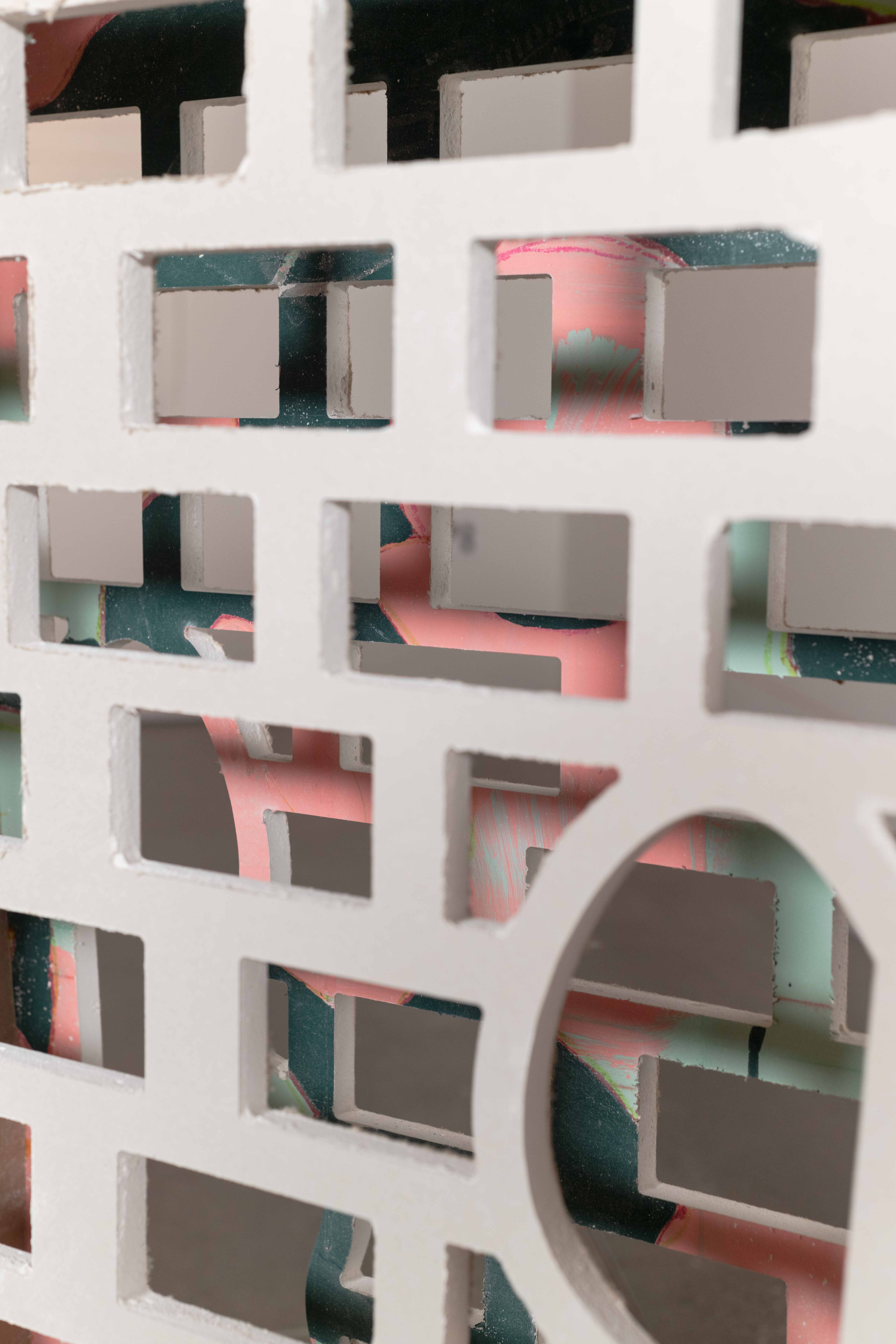 An outline of a trashcan created by to pieces of drywall with a 9” perforated piece of
drywall in-between. The inside of the trashcan can been seen through holes cut through the
drywall. There are painting on the side of the form.