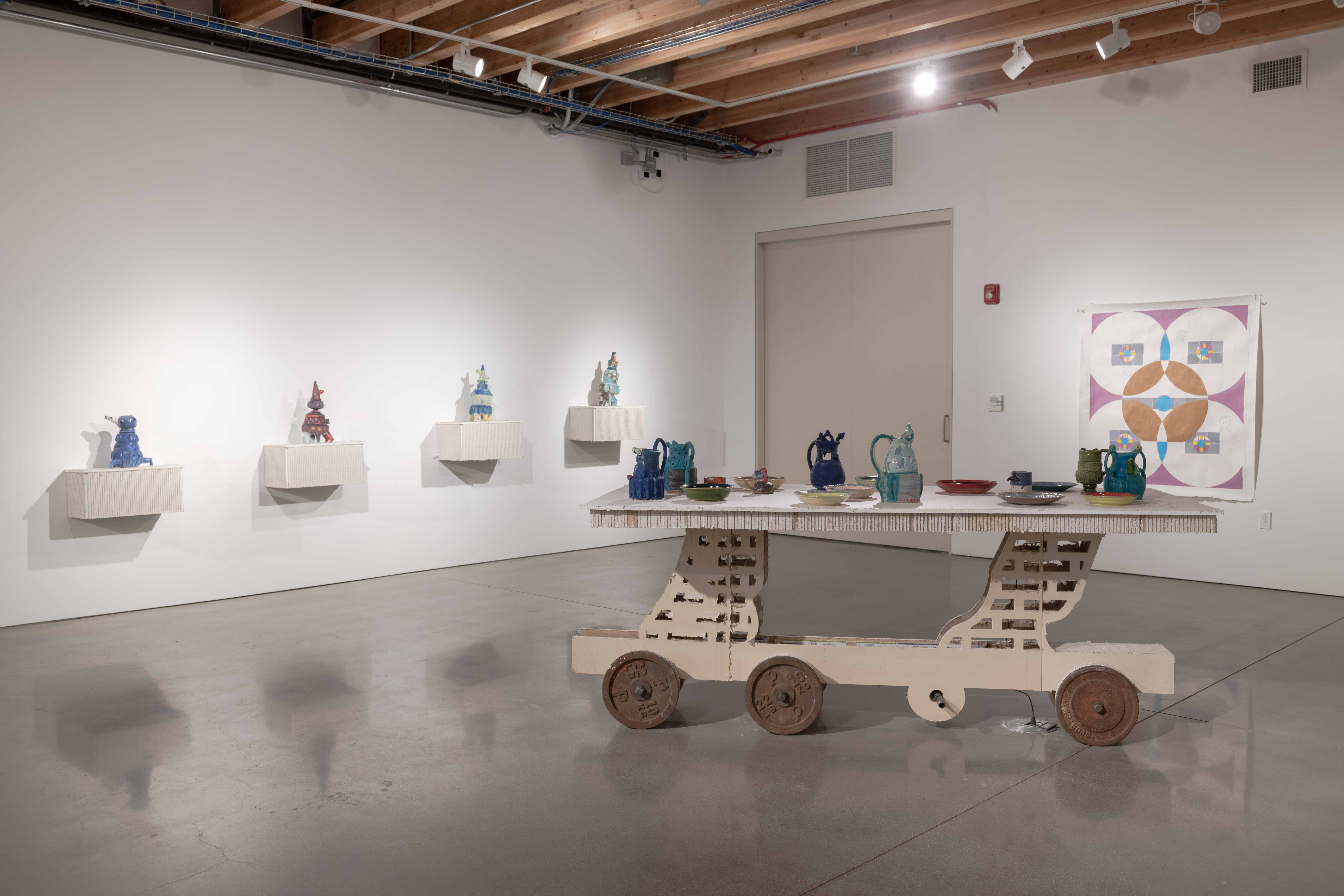 An outline of a trashcan created by to pieces of drywall with a 9” perforated piece of
drywall in-between. The inside of the trashcan can been seen through holes cut through the
drywall. There are painting on the side of the form.