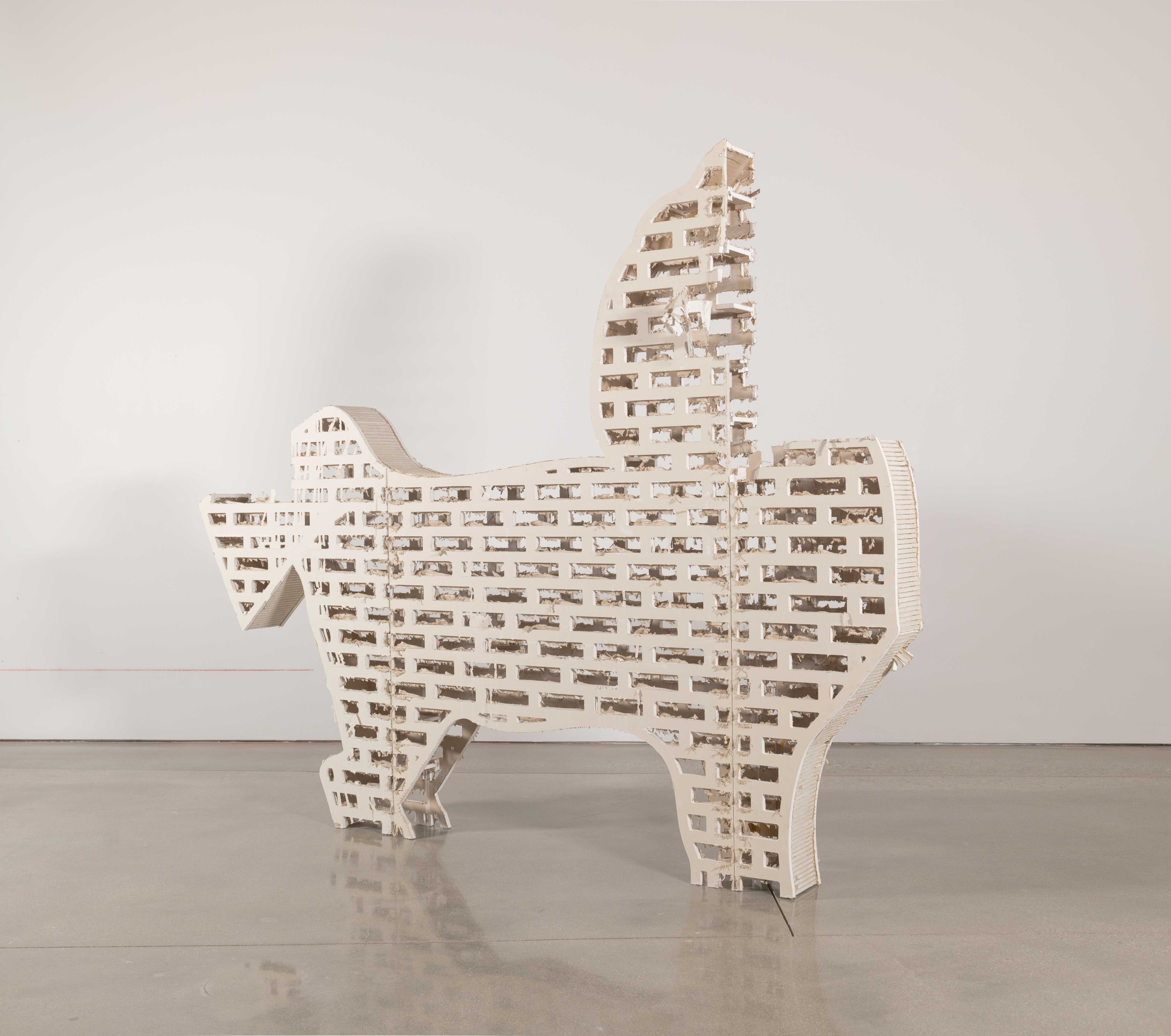 Drywall table with LED lights imbedded below the surface. 25 pound iron weights for
lifting are the tables wheels. The table legs are an outline of a horses feet. On top of the table
are an assorted gathering of brightly glazed Ceramic objects— Puzzle Jugs and WHO plates.